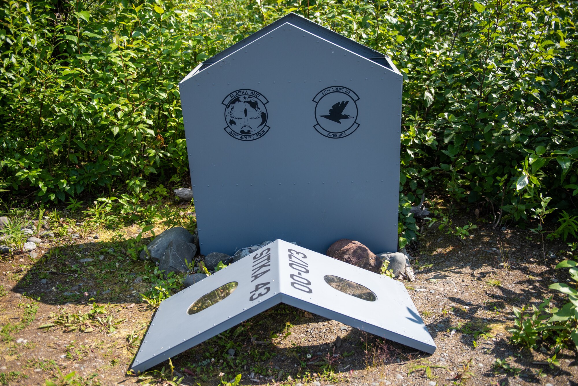 A metal bucket-like structure contains the remains of “Sitka 43” aircraft wreckage as Airmen assigned to Alaska Air National Guard’s 249th Airlift Squadron, 144th Airlift Squadron and U.S. Air Force 517th Airlift Squadron gathers for a final roll call memorial ceremony and a toast at Joint Base Elmendorf-Richardson, Alaska.