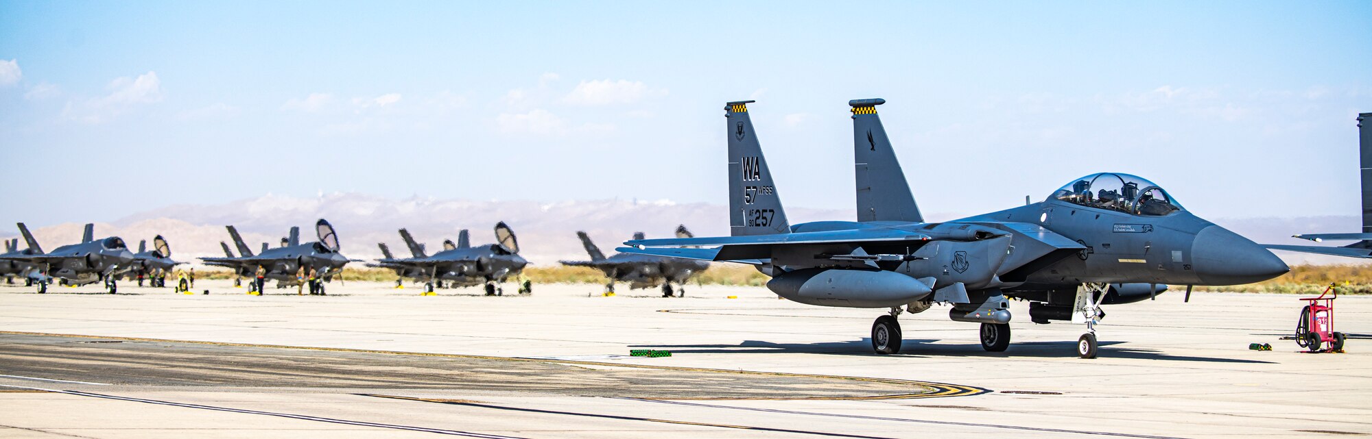F-22s, F-35s, F-15s and F-16s assigned to the U.S. Air Force Weapons School park on the historic flightline at Edwards Air Force Base, California. The USAF Weapons School teaches graduate-level instructor courses that provide the world's most advanced training in weapons and tactics employment.