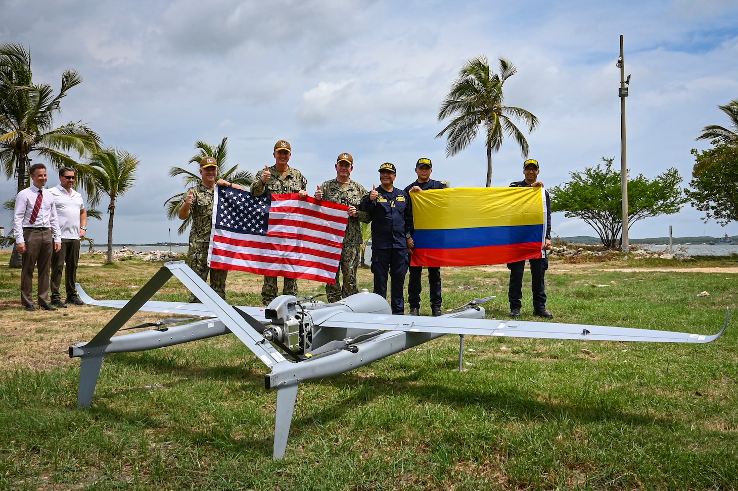 Photos of NITAS members from Colombia and the Republic of Korea discuss the Aerosonde MK4.7 Hybrid Quad unmanned aerial vehicle during demonstration of at the Club Naval Castillogrande during UNITAS LXIV, July 16, 2023.