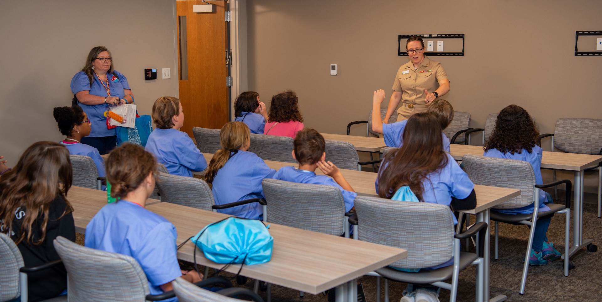 Lt. Kristen Shafer, STEM outreach coordinator and emergency medicine resident, explains naval uniforms and the naval hospital to elementary school students from Starbase Victory MedBase summer camp July 26 at Naval Medical Center Portsmouth. The tour was part of an effort by the school district to expose children to the world of STEM. (U.S. Navy photo by Mass Communication Specialist 2nd Class Dylan M. Kinee)
