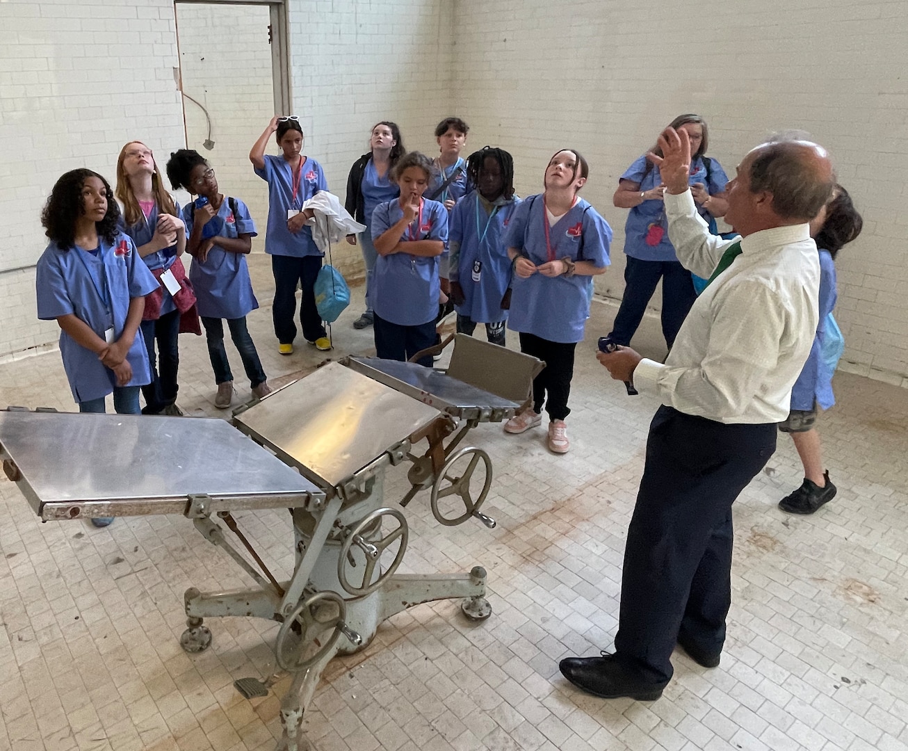 Mr. Pete Kopacz, executive director of Naval Medical Center Portsmouth, shows elementary school students from Starbase Victory MedBase summer camp the hospital’s 1910 operating room July 26 during a tour. The students toured the original portion of the hospital, built in 1830, and listened to presentations as part of an effort by the school district to expose children to the world of STEM. (U.S. Navy photo by W. Scott Epperson)