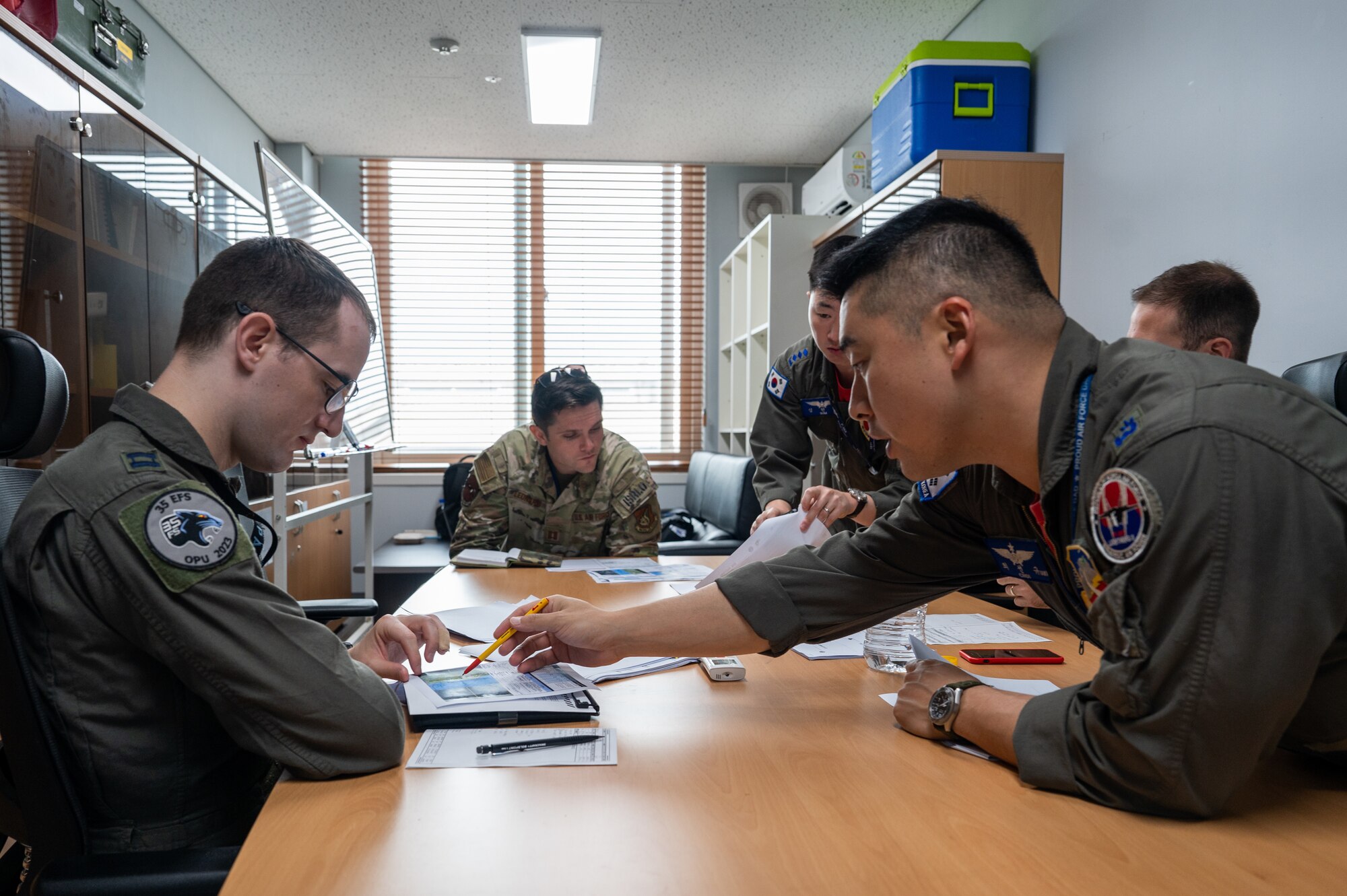 Republic of Korea Air Force Maj. Choi Sun Ltya details event plans with U.S. Air Force Capt. David Lee U.S.-ROK buddy squadron event at Cheonju Air Base