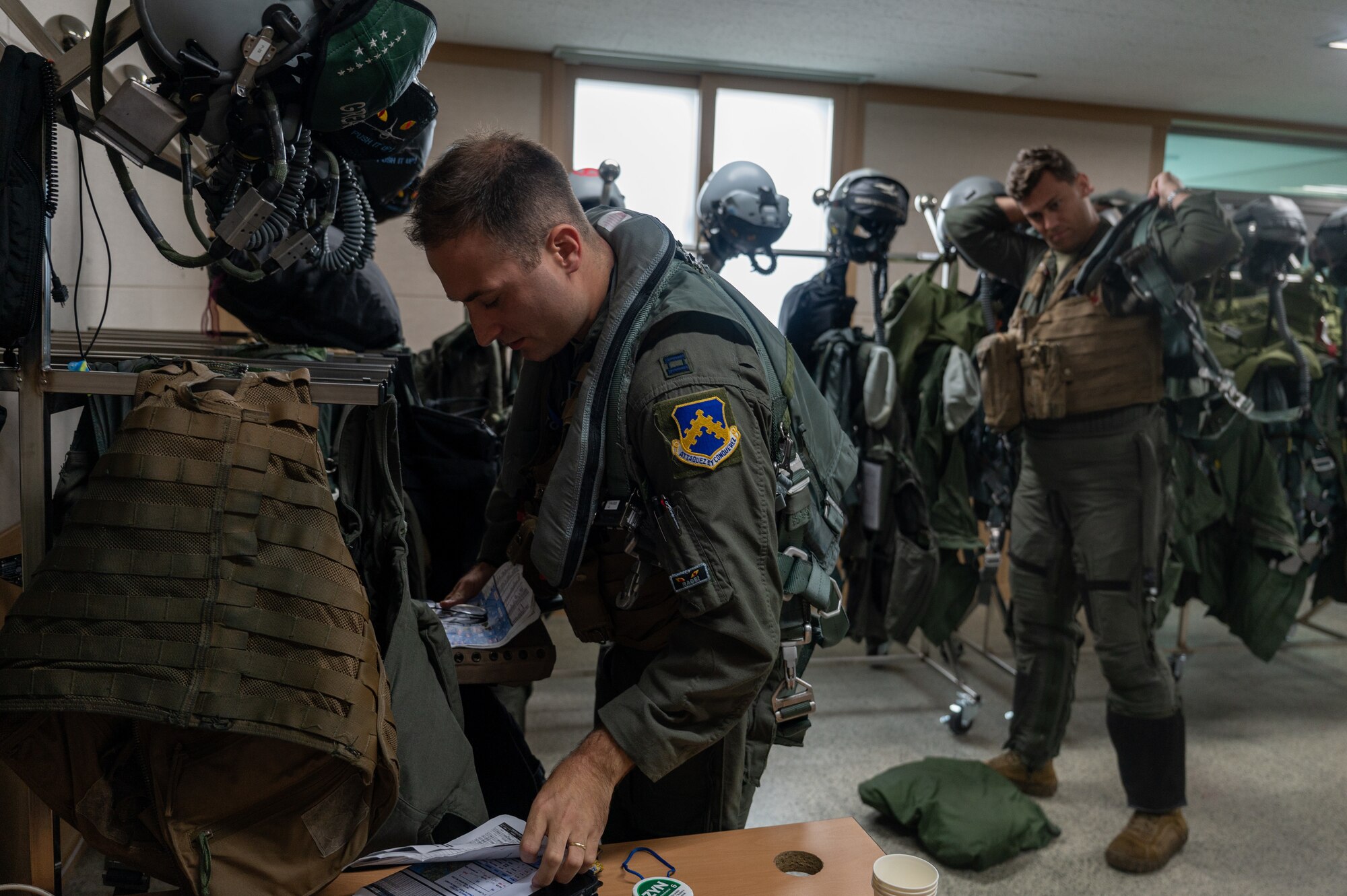 Capt. Nicholas Debonis and Capt. Jonathan Klinedon their flight suits during a U.S.-Republic of Korea buddy squadron event at Cheonju Air Base