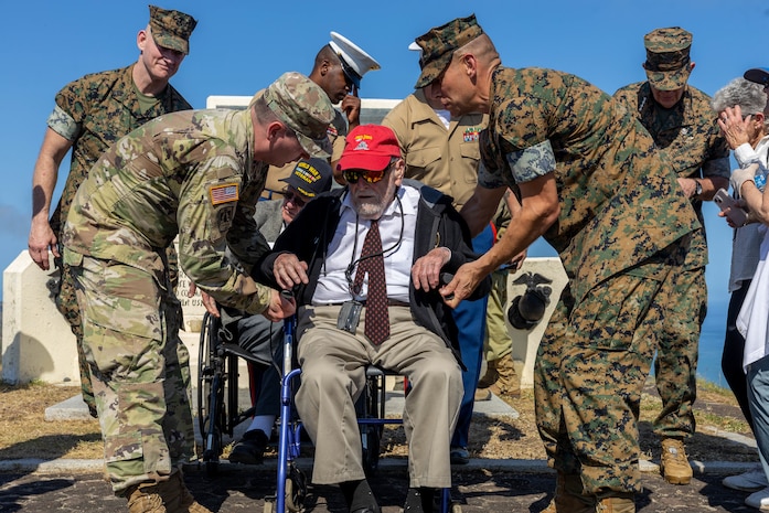 U.S. Air Force Lt. Gen. Ricky N. Rupp, commanding general of U.S. Forces Japan, and Brig. Gen. Adam Chalkley, the commanding general of 3rd Marine Logistics Group, escort a Battle of Iwo Jima veteran atop Mt. Suribachi after the 78th Reunion of Honor ceremony, Iwo To, Japan, March 25, 2023. The Reunion of Honor ceremony is held annually to bring together leaders from the U.S. and Japan, veterans, distinguished guests, and their family members to pay tribute to service members lost during the Battle of Iwo Jima, and is a testament to the ironclad U.S.-Japan alliance which has blossomed over the past 78 years. (U.S. Marine Corps photo by Lance Cpl. Federico Marquez)