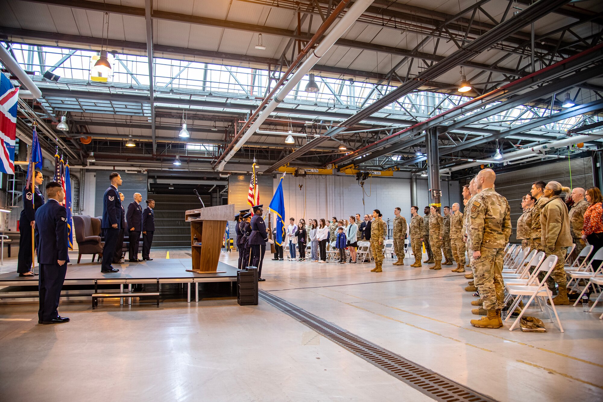 Airmen and attendees from the 501st Combat Support Wing stand at attention during the national anthem at RAF Alconbury, England, May 30, 2023. The ceremony is a military tradition that represents a formal transfer of a unit’s authority from one commander to another. (U.S. Air Force photo by Staff Sgt. Eugene Oliver)
