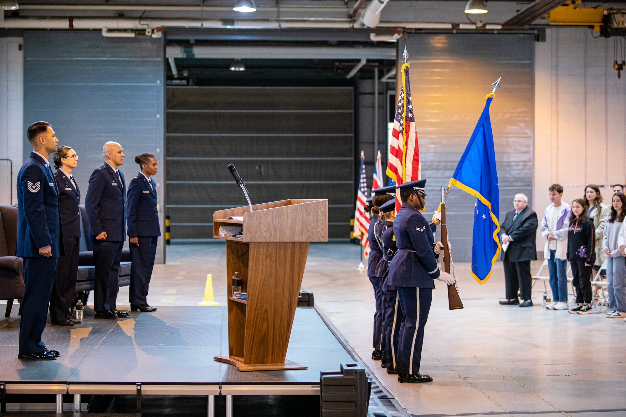 Airmen and attendees from the 501st Combat Support Wing stand at attention during the national anthem at RAF Alconbury, England, May 30, 2023. The ceremony is a military tradition that represents a formal transfer of a unit’s authority from one commander to another. (U.S. Air Force photo by Staff Sgt. Eugene Oliver)