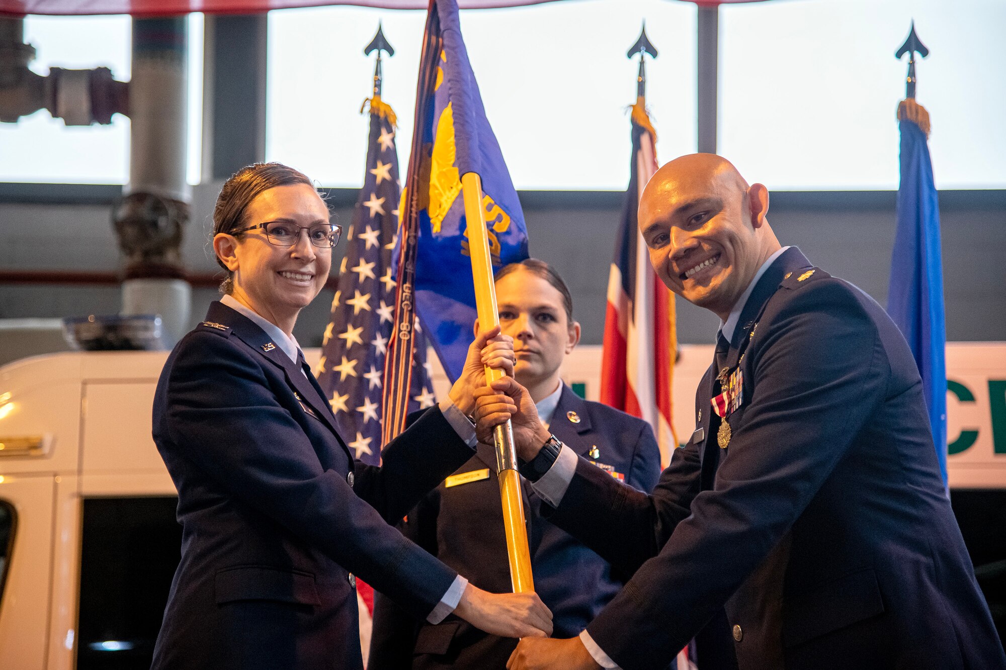 U.S. Air Force Col. Valerie Long, 423d Air Base Group commander, left, receives the 423d Medical Squadron guidon from Lt. Col. Darrell Lee, 423d MDS outgoing commander, during a change of command ceremony at RAF Alconbury, England, May 30, 2023. During his command, Lee was responsible for the delivery of comprehensive medical, nursing, mental health and dental services supporting 12 multi-service, multi-national and interagency mission partners. (U.S. Air Force photo by Staff Sgt. Eugene Oliver)