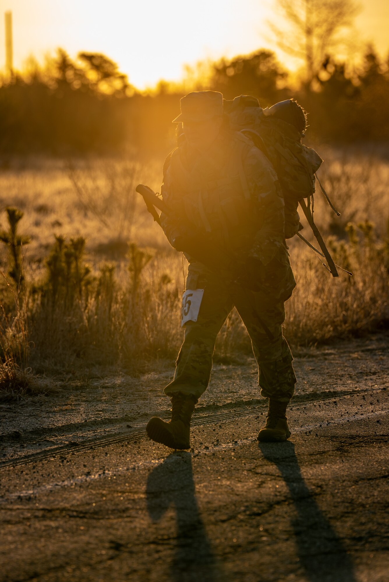U.S. Air Force Tech. Sgt. Jessica Gallis, equipment manager with the 104th Logistics Readiness Squadron, competes in the 2023 Massachusetts National Guard Best Warrior Competition's 12-mile ruck event March 25, 2023 at Joint-Base Cape Cod, Massachusetts. The three-day competition covered areas of expertise to include physical fitness, weapons proficiency, land navigation, and first aid. (U.S. Air National Guard courtesy photo)