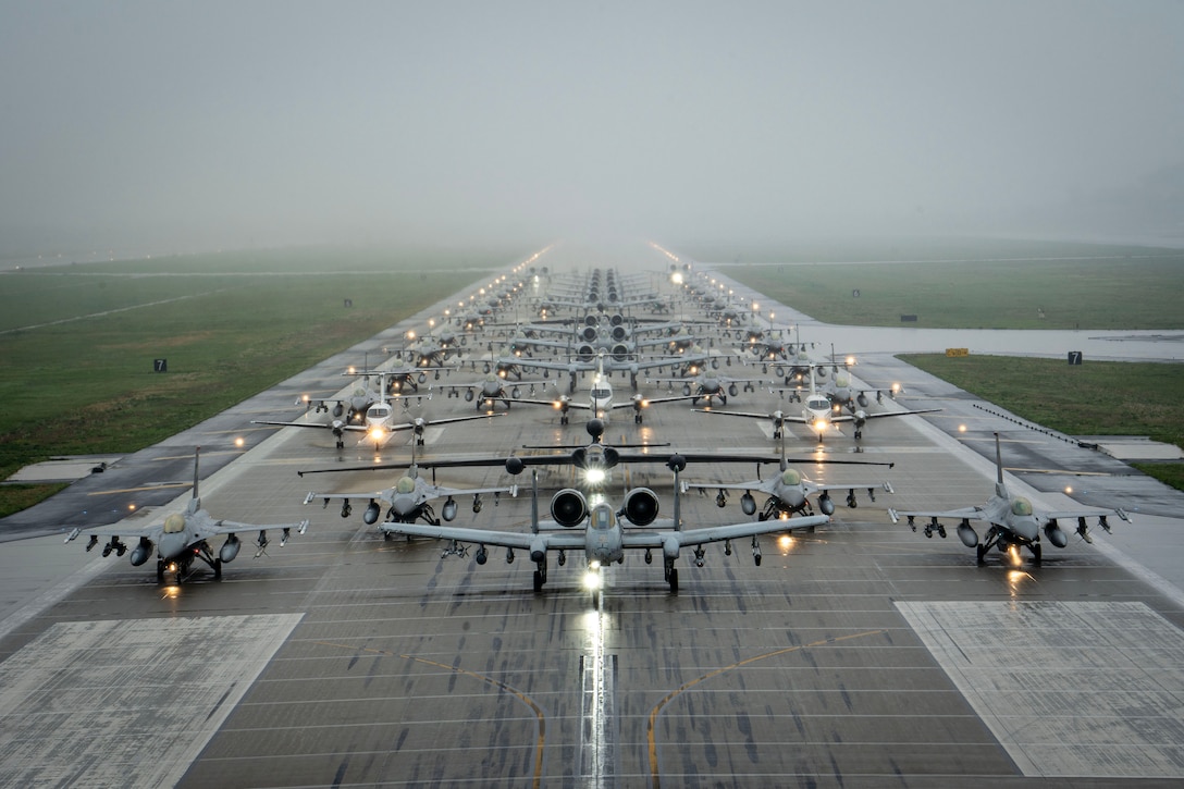 Rows of Air Force aircraft are lined up on a runway.