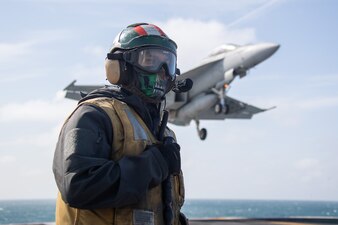 Aviation Boatswain's Mate (Handling) 2nd Class Brandon Marino, from Riverside, California, assigned to the world's largest aircraft carrier USS Gerald R. Ford's (CVN 78) air department, performs duties as the enlisted landing safety officer while an F/A-18F Super Hornet attached to the "Black Lions" of Strike Fighter Squadron (VFA) 213, approaches the flight deck, May 31, 2023.