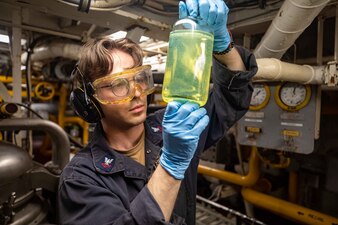 Gas Turbine Systems Technician (Mechanical) 2nd Class Koby Derrico from Surprise, Arizona, inspects a fuel sample for contaminants aboard the Ticonderoga-class guided-missile cruiser USS Antietam (CG 54) in the North Pacific Ocean, June 1, 2023.