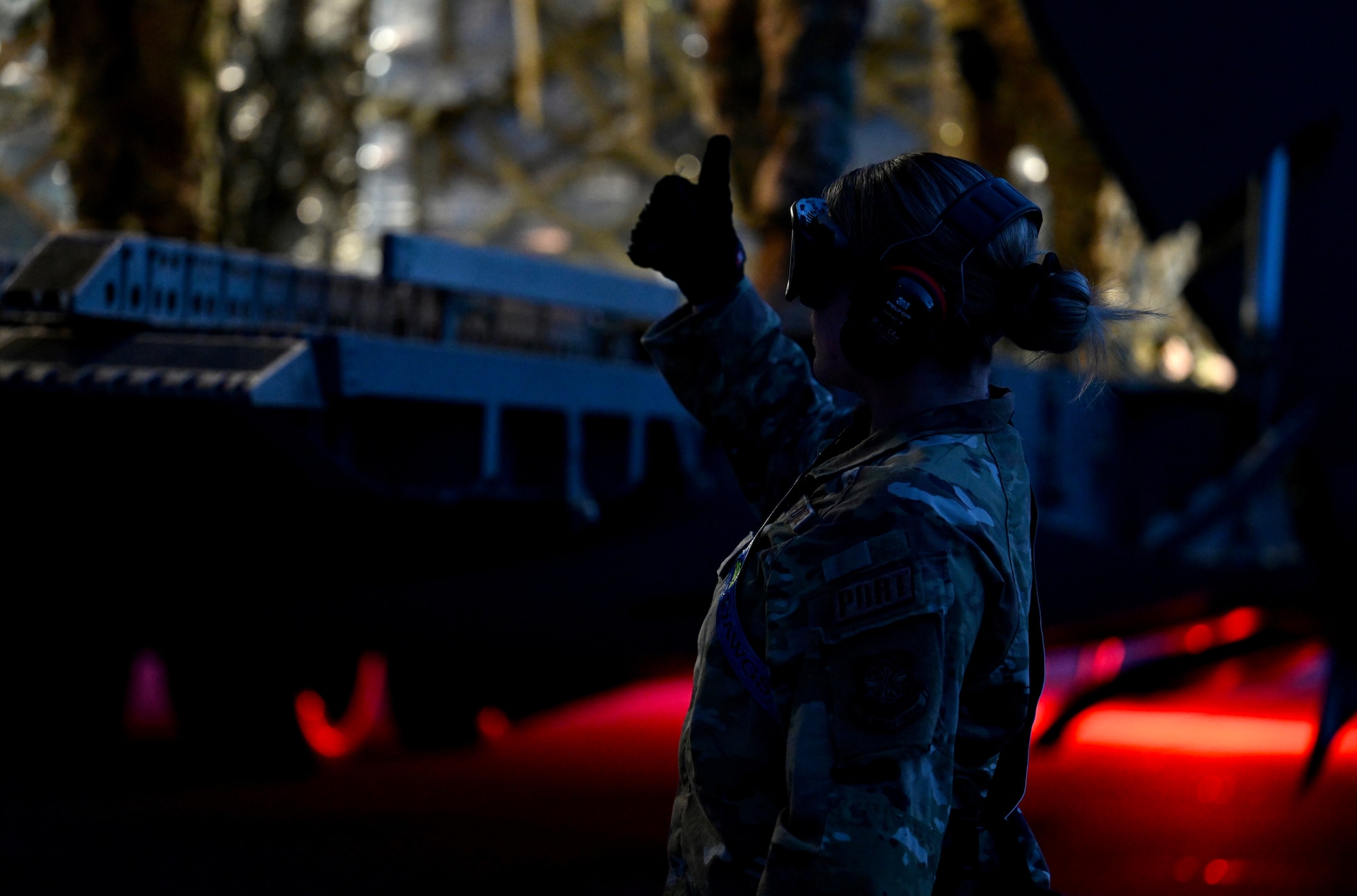 U.S. Air Force Senior Airman Courtney Decker assigned to the 721st Aerial Port Squadron, assists with guiding an aircraft cargo loader during Exercise Defender Europe 23 at Larissa Air Base, Greece, May 13, 2023.