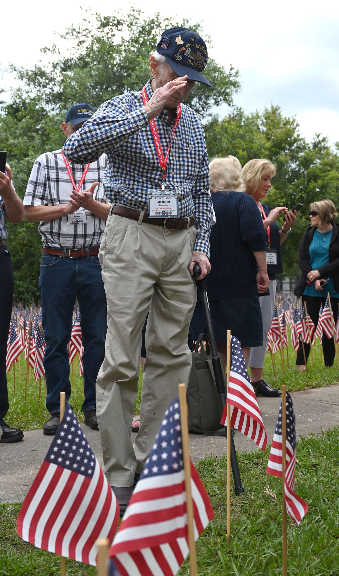 U.S. Army Air Force Capt. John “Lucky” Luckadoo, 100th Bomb Group pilot and World War II survivor, salutes the flag after placing it during the Flags for the Fallen ceremony at the 100th Bomb Group reunion, National Museum of the Mighty Eighth Air Force in Savannah, Georgia, May 25, 2023. Twenty-six-thousand flags were placed leading up to Memorial Day to honor those men from the Eighth Air Force who lost their lives and never made it home. Of those, 757 were from the 100th Bomb Group. (U.S. Air Force photo by Karen Abeyasekere)