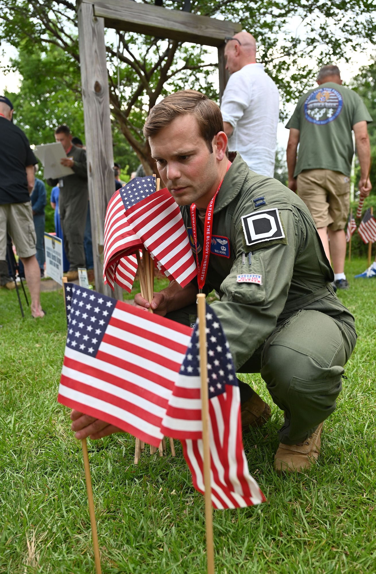 U.S. Air Force Capt. Brad Mokris, 351st Air Refueling Squadron, assistant B-flight commander and KC-135 Stratotanker aircraft commander, places flags at the 100th Bomb Group reunion and Flags for the Fallen event at the National Museum for the Mighty Eighth Air Force, in Savannah, Georgia, May 25, 2023. In the days leading up to Memorial Day, 26,000 flags were placed, each representing an Eighth Air Force Airmen lost during World War II. The 100th BG lost 757 men, each represented by a flag placed by attendees at the 100th Bomb Group reunion, including Airmen from RAF Mildenhall. (U.S. Air Force photo by Karen Abeyasekere)