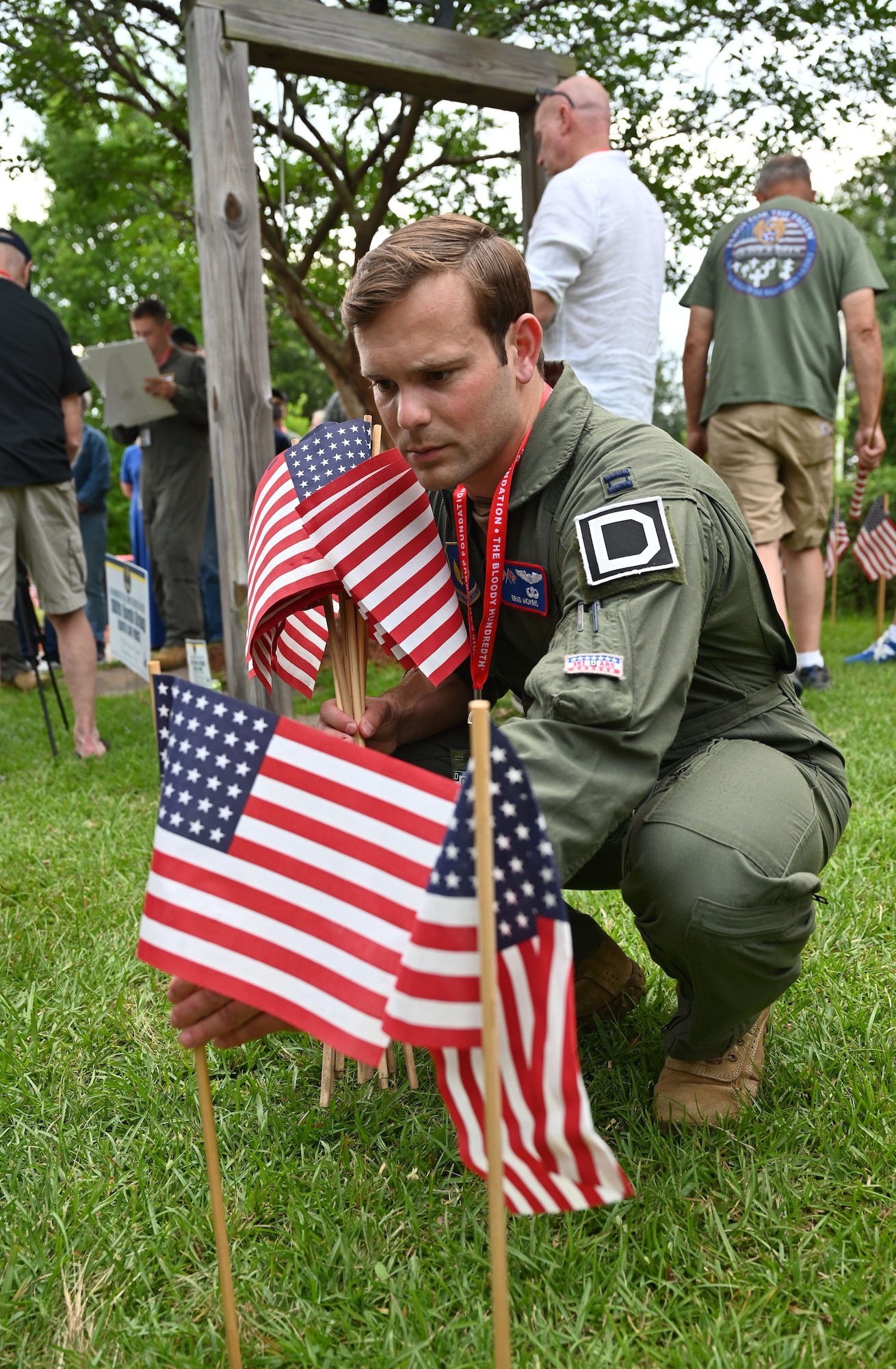 U.S. Air Force Capt. Brad Mokris, 351st Air Refueling Squadron, assistant B-flight commander and KC-135 Stratotanker aircraft commander, places flags at the 100th Bomb Group reunion and Flags for the Fallen event at the National Museum for the Mighty Eighth Air Force, in Savannah, Georgia, May 25, 2023. In the days leading up to Memorial Day, 26,000 flags were placed, each representing an Eighth Air Force Airmen lost during World War II. The 100th BG lost 757 men, each represented by a flag placed by attendees at the 100th Bomb Group reunion, including Airmen from RAF Mildenhall. (U.S. Air Force photo by Karen Abeyasekere)
