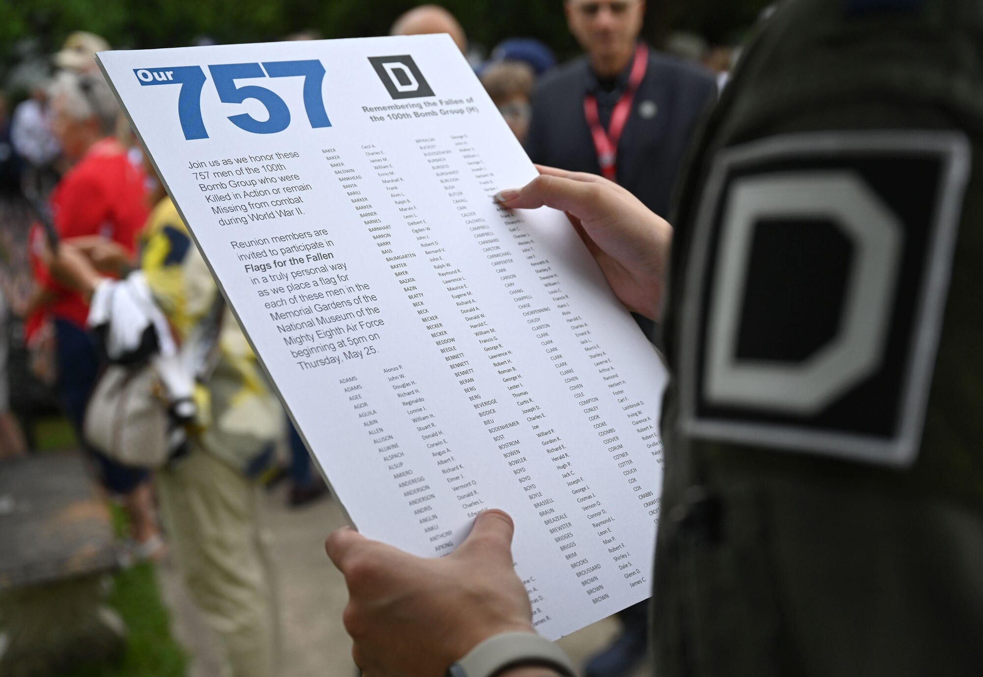 U.S. Air Force Capt. Katie Gibson, 100th Operations Support Squadron tactics assistant flight commander and KC-135 Stratotanker aircraft commander, reads some of the 757 names of 100th Bomb Group Airmen who were lost during World War II, at the Flags for the Fallen ceremony during the 100th Bomb Group reunion, National Museum of the Mighty Eighth Air Force, Savanna, Georgia, May 25, 2023. Airmen from Royal Air Force Mildenhall, volunteers from the 100th Bomb Group Memorial Museum at Thorpe Abbotts, and hundreds of family members of 100th BG veterans, all placed flags for the 757 Airmen from the 100th Bomb Group who never returned home. The flags had 48 stars to represent the flag under which the veterans served during World War II. (U.S. Air Force photo by Karen Abeyasekere)