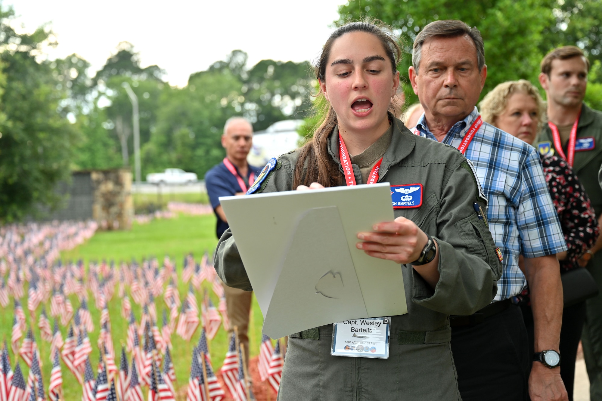 U.S. Air Force Capt. Wesleigh Bartells, 351st Air Refueling Squadron pilot, reads some of the 757 names of 100th Bomb Group Airmen who were lost during World War II, at the Flags for the Fallen ceremony during the 100th Bomb Group reunion, National Museum of the Mighty Eighth Air Force, Savanna, Georgia, May 25, 2023. Airmen from Royal Air Force Mildenhall, volunteers from the 100th Bomb Group Memorial Museum at Thorpe Abbotts, and hundreds of family members of 100th BG veterans, all placed flags for the 757 Airmen from the 100th Bomb Group who never returned home. The flags had 48 stars to represent the flag under which the veterans served during World War II. (U.S. Air Force photo by Karen Abeyasekere)