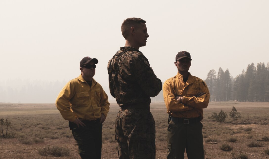 Sam Paris (left), Ethan Perrine, firefighters, Engine Four, Madison Fire Department, and U.S. Marine Corps Staff Sgt. Joshua Scheidt, mountain communications chief instructor, Marine Corps Mountain Warfare Training Center, Bridgeport, Calif., survey areas of the training center in response to the Slink Fire at the Training Center, Sept. 2, 2020. MCMWTC is integrating multiple firefighting agencies from across several states to battle the fire and mitigate damage to the training areas that are essential to Marine Corps Service Level Training. (U.S. Marine Corps photo by Lance Cpl. Shane T. Beaubien)