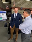 IMAGE: Virginia Tech student Kevin Matos talks with Dale Sisson, Jr., SES, Naval Surface Warfare Center Dahlgren Division Technical Director, at the Virginia Tech Mechanical Engineering Senior Design Expo in April.