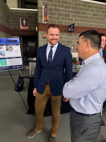 IMAGE: Virginia Tech student Kevin Matos talks with Dale Sisson, Jr., SES, Naval Surface Warfare Center Dahlgren Division Technical Director, at the Virginia Tech Mechanical Engineering Senior Design Expo in April.