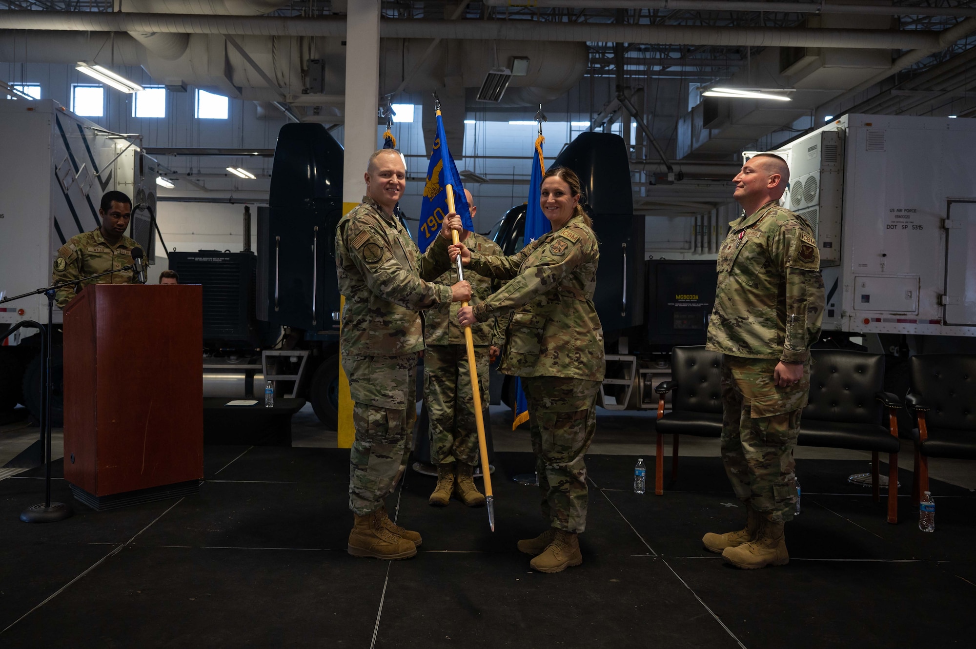 90 MXG commander passes the guidon to incoming 790 MXS commander