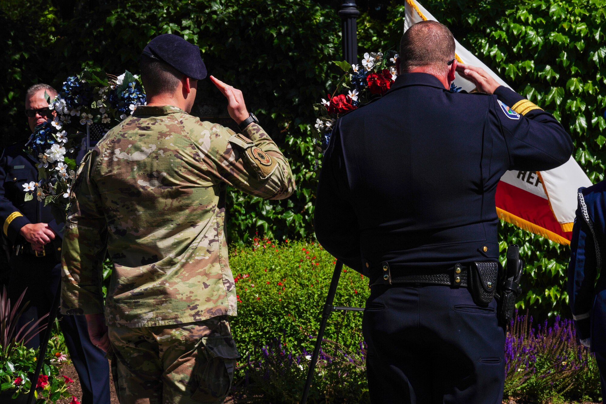 U.S. Air Force Maj. Patrick Livingstone, 9th Security Forces Squadron commander, renders a salute along with Yuba City Police Department Chief Brian Baker to the military memorial wreath during the 2023 Regional Peace Officers’ Memorial Ceremony, May 17, 2023, in Yuba City, California.