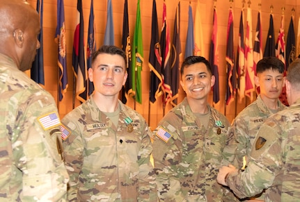 Staff Sgt. Jose Luis Joachin, center right, and Spc. Jason Riley, right, were named CECOM’s NCO and Soldier of the Year, respectively, for winning U.S. Army Communications-Electronics Command’s first Best Warrior Competition, held May 8-12 at Aberdeen Proving Ground, Maryland. The two Soldiers are stationed at the U.S. Army Medical Materiel Center-Europe, a direct reporting unit to Army Medical Logistics Command. (Maya Green)