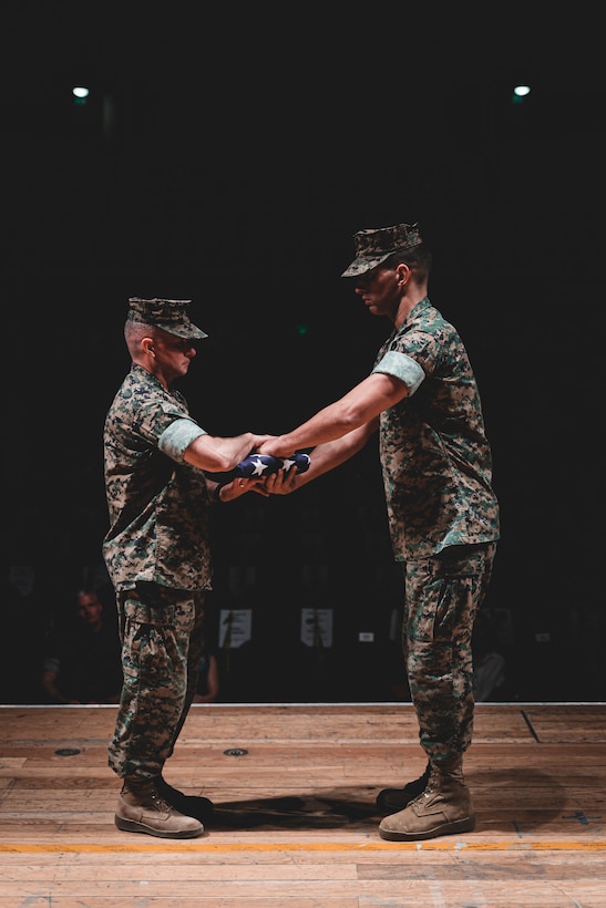 A U.S. Marine is presented colors