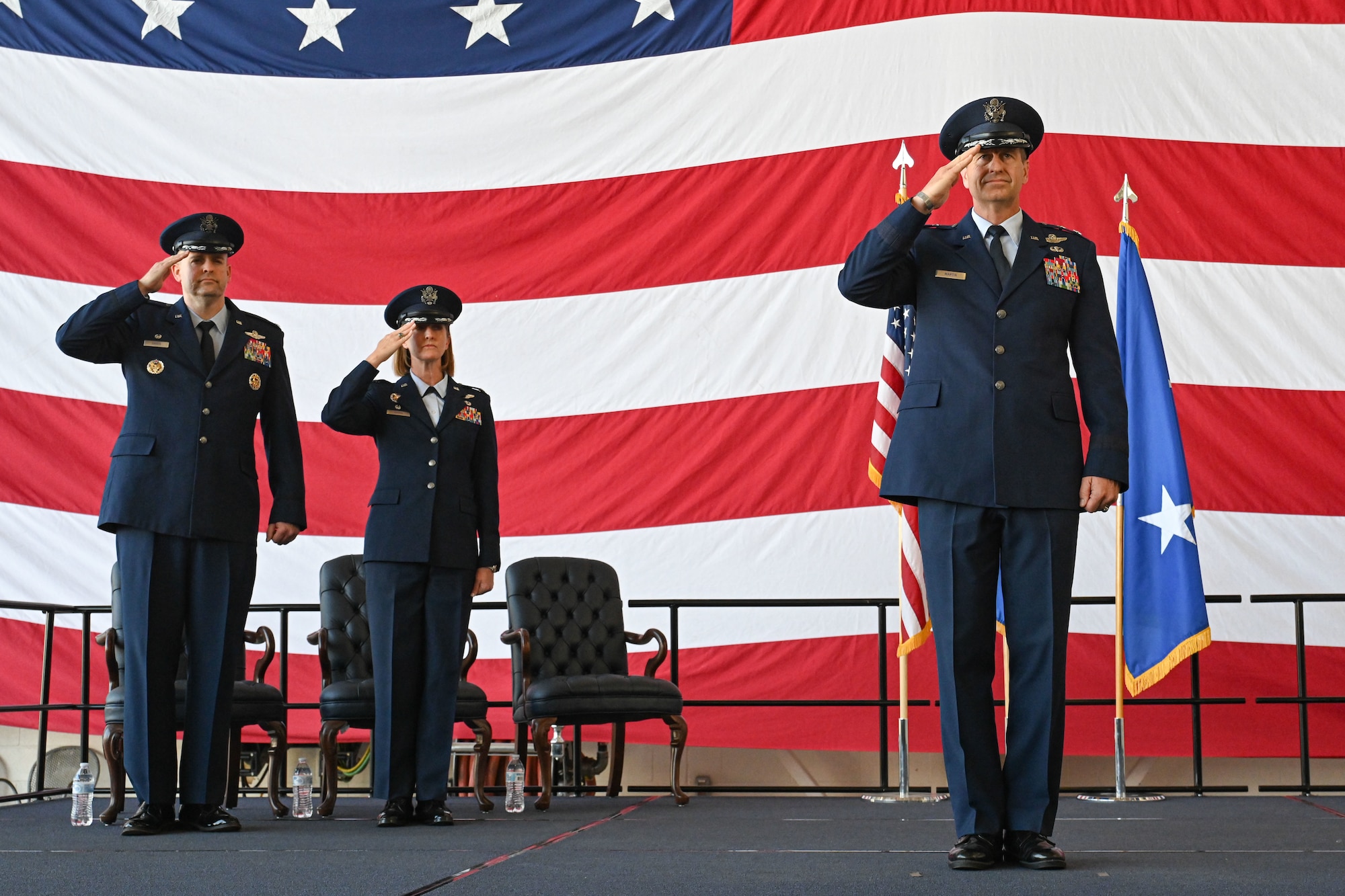 Airmen from the 19th Airlift Wing participate in a change of command ceremony in an airplane hangar