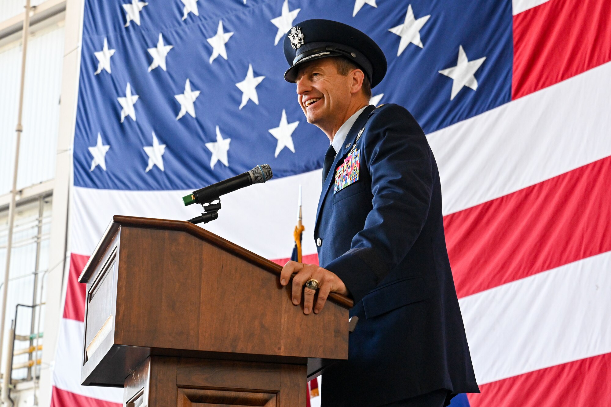 Airmen from the 19th Airlift Wing participate in a change of command ceremony in an airplane hangar