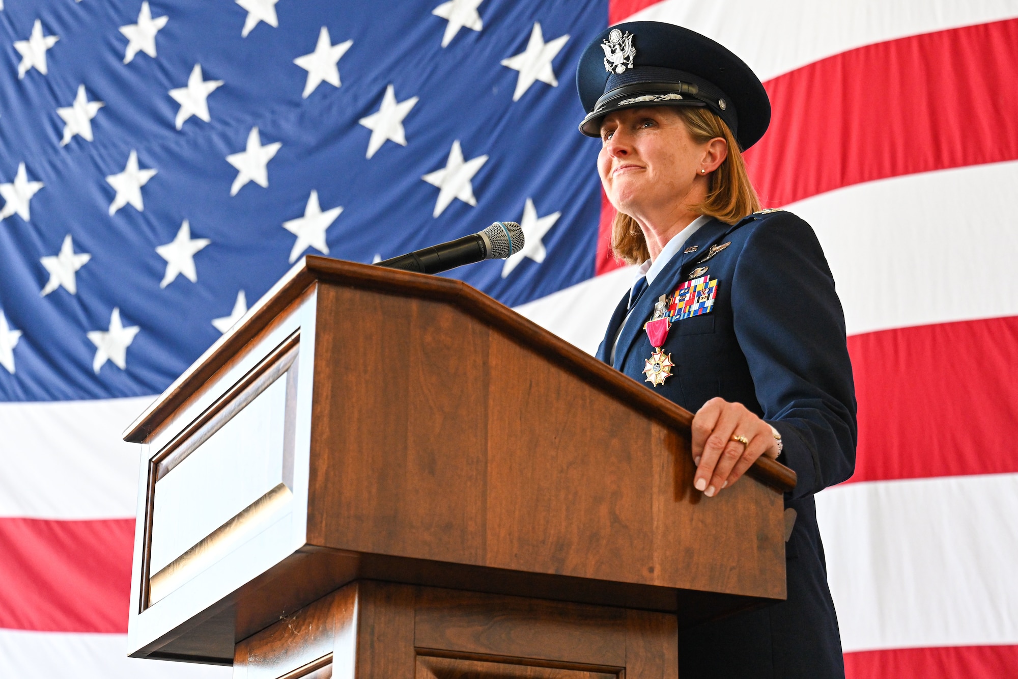 Airmen from the 19th Airlift Wing participate in a change of command ceremony in an airplane hangar
