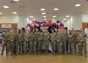 Team Minot Airmen pose for a group photo with Col. Daniel Hoadley, 5th Bomb Wing commander, and Col. Kenneth McGhee, 91st Missile Wing commander, at the LGBTQI+ Pride Month opening ceremony at Minot Air Force Base, North Dakota, June 1, 2023. LGBTQI+ Pride Month is celebrated annually in June to honor members of the LGBTQI+ community. (U.S. Air Force photo by Airman 1st Class Kyle Wilson)