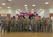 Team Minot Airmen pose for a group photo with Col. Daniel Hoadley, 5th Bomb Wing commander, and Col. Kenneth McGhee, 91st Missile Wing commander, at the LGBTQI+ Pride Month opening ceremony at Minot Air Force Base, North Dakota, June 1, 2023. LGBTQI+ Pride Month is celebrated annually in June to honor members of the LGBTQI+ community. (U.S. Air Force photo by Airman 1st Class Kyle Wilson)