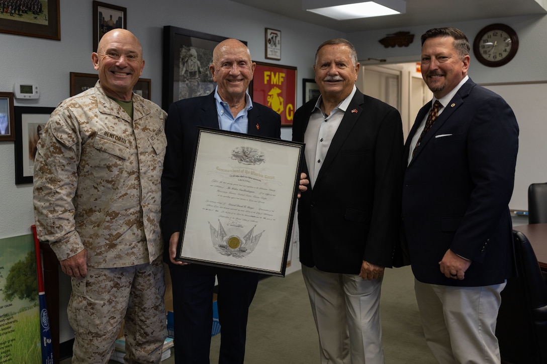 U.S. Marine Corps Maj. Gen. Austin Renforth presents Walter Vanbenthuysen with an "Honorary Marine" certificate