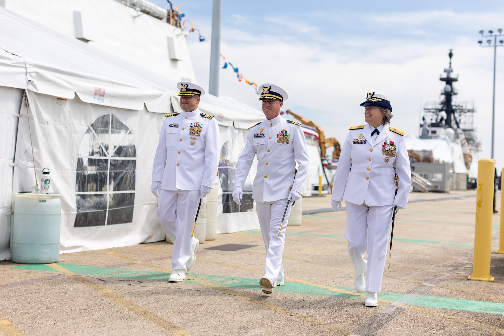 Capt. Justin Matthew Carter (left), Capt. Matthew T. Brown (middle) and Rear Adm. Laura Dickey (right) walk towards USCGC Hamilton's (WMSL 753) change of command ceremony, held at the Federal Law Enforcement Training Center, June 1, 2023, in North Charleston, South Carolina. The change of command ceremony marks a transfer of total responsibility and authority from one individual to another. (U.S. Coast Guard photo by U.S. Coast Guard Petty Officer 1st Class Turner Adair)