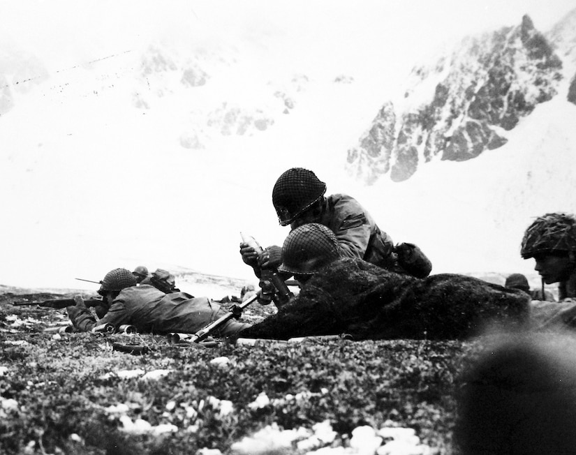 Allied Amphibious Landing on Attu Island, 11 May 1943. High on a Ridge overlooking Chichagof Harbor, American soldiers load a shell into a small mortar. Chichagof Harbor was the last Japanese stronghold to fall on Attu Island.