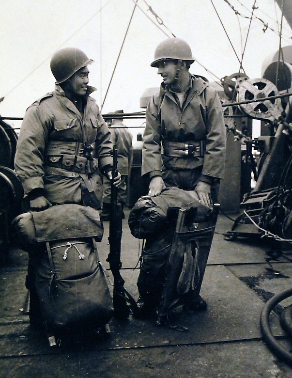 Alaskan scouts stand by on deck of USS Heywood (APA-6) ready to go ashore in landing boats off Attu, Aleutian Islands, 11 May 1943. Left to right: SGT B. Moriwaki and SSG D. Spaulding, who both work with Army Intelligence. SGT Moriwaki is an American-born Japanese interpreter.