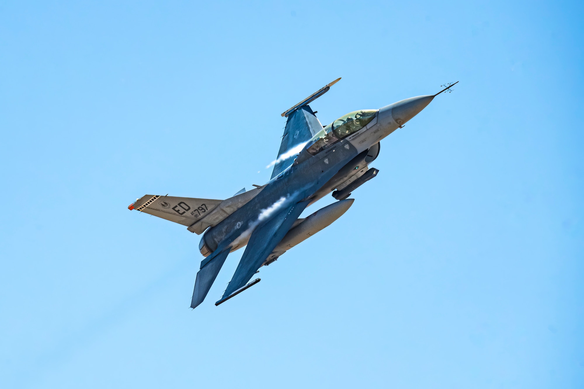 An F-16D Fighting Falcon flies over the Precision Impact Range Area on Edwards Air Force Base, California, May 10. The U.S. Air Force Test Pilot School Space Test Course Class 23-1 utilized multi-domain assets during their capstone project to provide vital info for aircraft pilots to aid in target acquisition, battle damage assessment and combat search and rescue. (Air Force photo by Giancarlo Casem)
