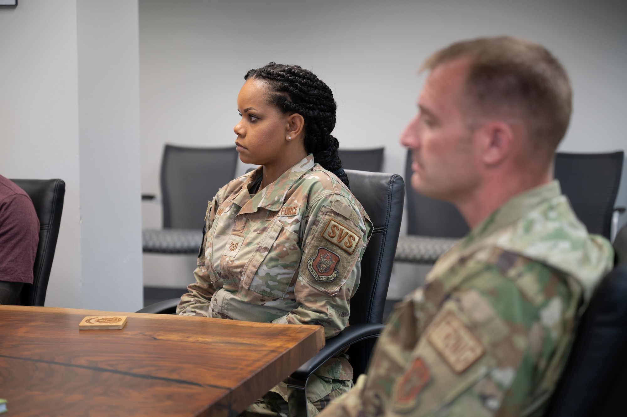 Two NCOs from the 349th FSS listen to the 349 FSS commander explain the priorities and goals handed down by the MAJCOM in May 2022.