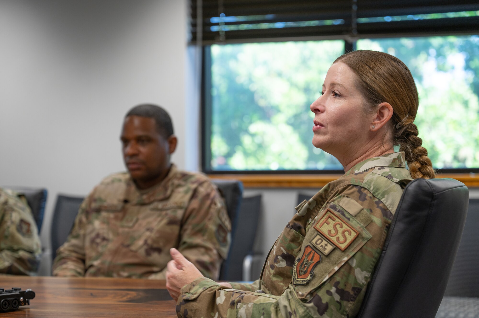 The 349 FSS commander is explaining readiness directives for the MAJCOM to her staff.