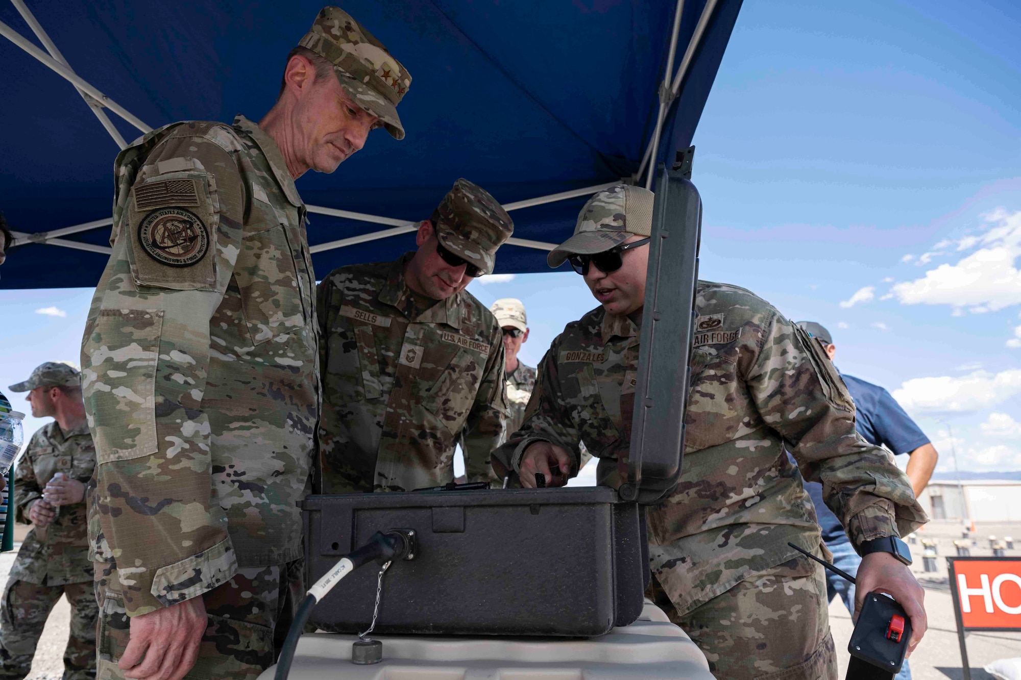 U.S. Air Force Staff Sgt. Brianna Gonzales, 635th Materiel Maintenance Squadron electrical systems supervisor, right, demonstrates how the emergency airfield lighting system works at Holloman Air Force Base, New Mexico, May 23, 2023. The EALS is designed to be rapidly installed at contingency airfields or at other locations that need temporary airfield lighting. (U.S. Air Force photo by Senior Airman Antonio Salfran)