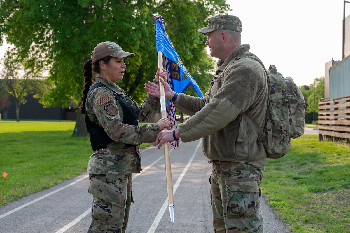 Master Sgt. Robin Barber, the 934th Security Forces Squadron 1st Sgt., left, retrieves the guidon from 1st Lt. Sean Rudin, the 934 SFS fire team lead, as part of a 12-hour ruck to remember the fallen during National Police Week 2023 at the Minneapolis-St. Paul Air Reserve Station, May 19, 2023. National Police Week 2023 was held from May 14th to May 20th to honor those who have served and are currently serving in the Law Enforcement profession. (U.S. Air Force photo by Senior Airman Matthew Reisdorf)