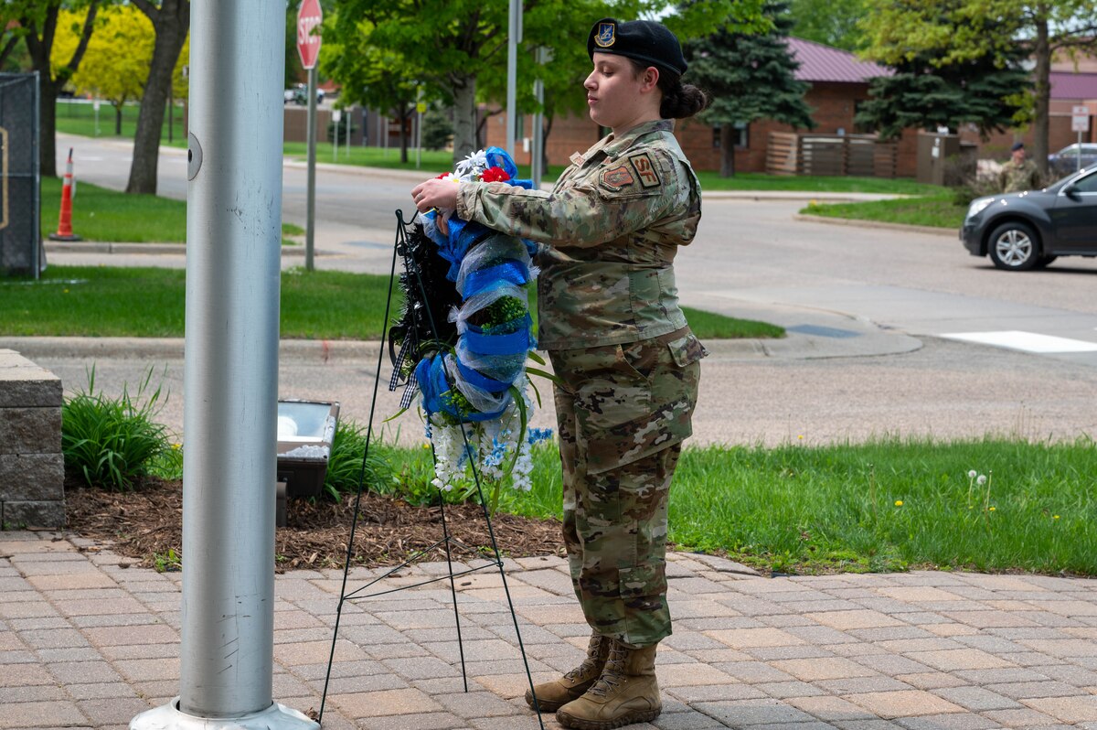 Senior Airman Nadia Robinson, a 934th Security Forces Squadron response force member, lays a wreath during the National Police Week 2023 ceremony at the Minneapolis-St. Paul Air Reserve Station, Minnesota, May 17, 2023. National Police Week 2023 was held from May 14th to May 20th to honor those who have served and are currently serving in the Law Enforcement profession. (U.S. Air Force photo by Senior Airman Matthew Reisdorf)