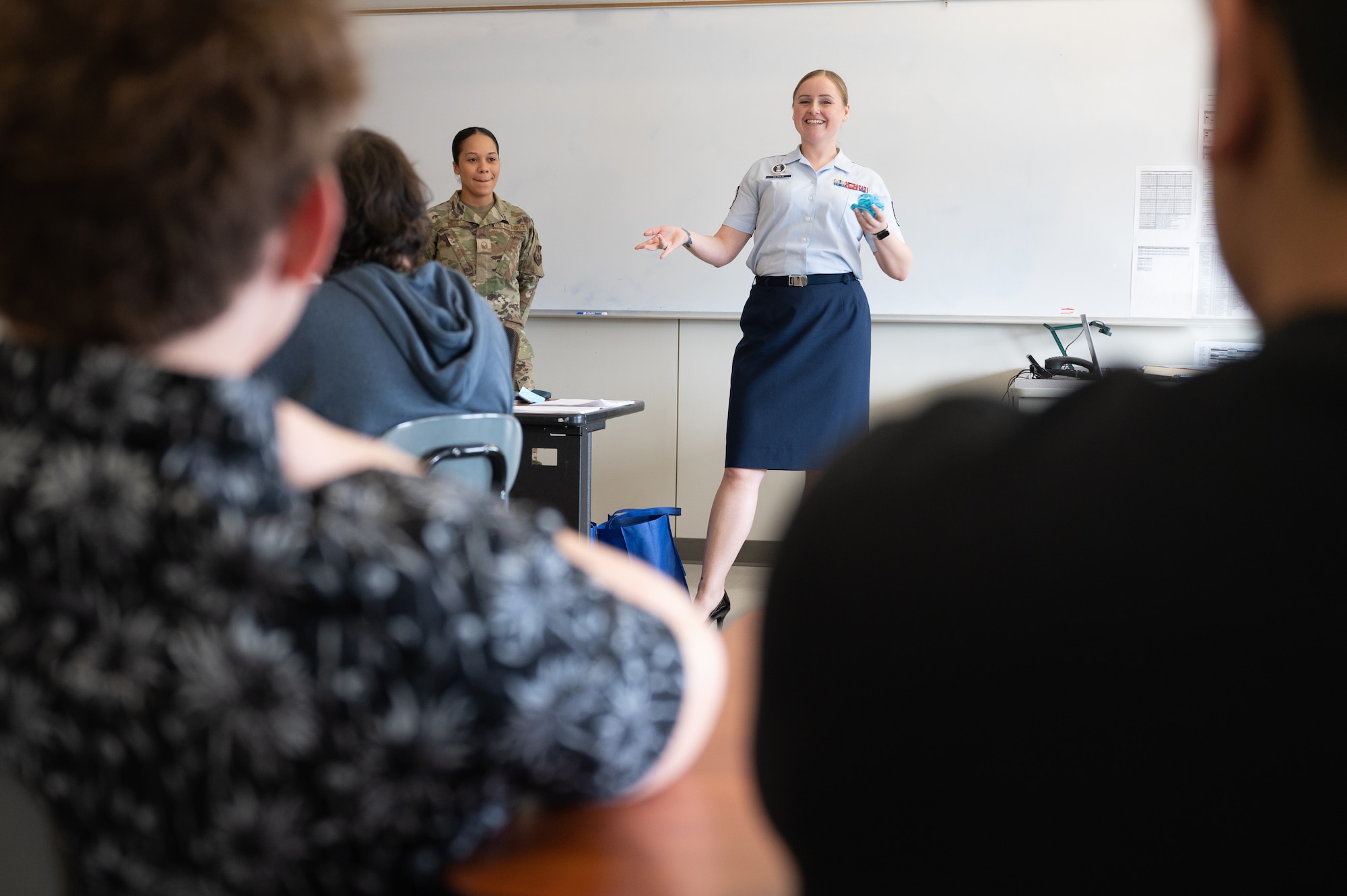 Image of Airmen speaking to students in a classroom.