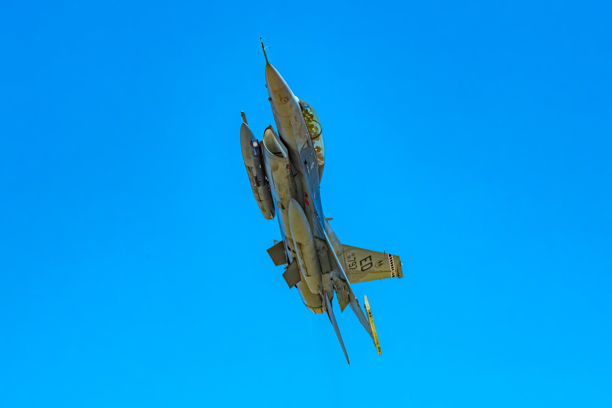 An F-16D Fighting Falcon flies over the Precision Impact Range Area on Edwards Air Force Base, California, May 10. The U.S. Air Force Test Pilot School Space Test Course Class 23-1 utilized multi-domain assets during their capstone project to provide vital info for aircraft pilots to aid in target acquisition, battle damage assessment and combat search and rescue. (Air Force photo by Giancarlo Casem)