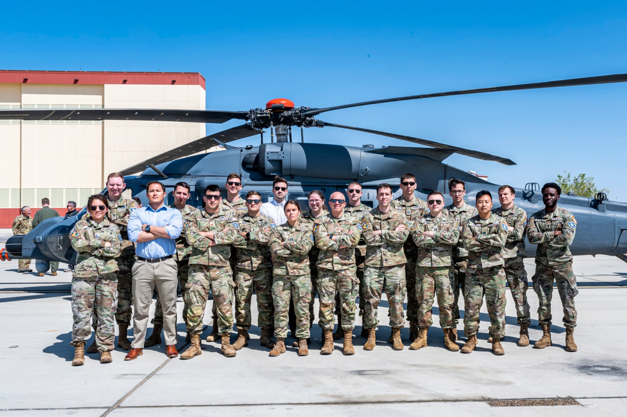 U.S. Air Force Test Pilot School Space Test Course Class 23-1 pose for a class photo in front of an HH-60W Jolly Green II helicopter at Edwards Air Force Base, California, May 10. As part of the USAFTPS STC Class 23-1 capstone project, the students utilized multi-domain imagery assets to conduct battle damage assessment, target acquisition and combat search and rescue operations. (Air Force photo by Giancarlo Casem)