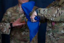 Pictured above is a close-up of three people rolling the flag.