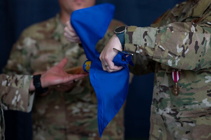 Pictured above is a close-up of three people rolling the flag.