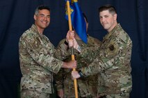 Pictured above are two people holding a flag.