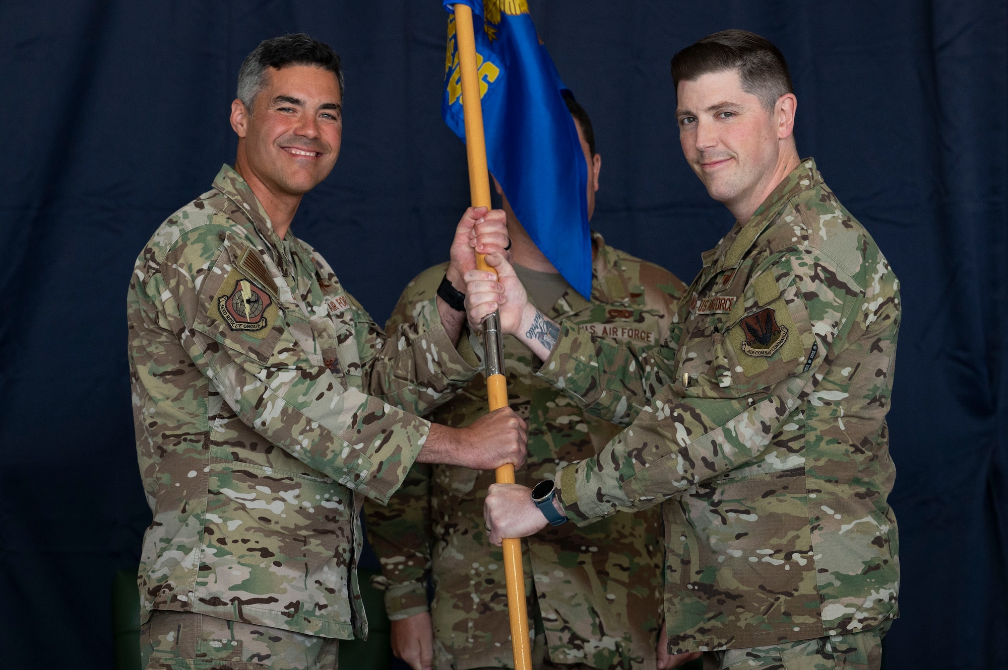 Pictured above are two people holding a flag.